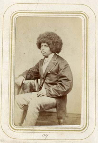 Black and white photograph of a seated black man