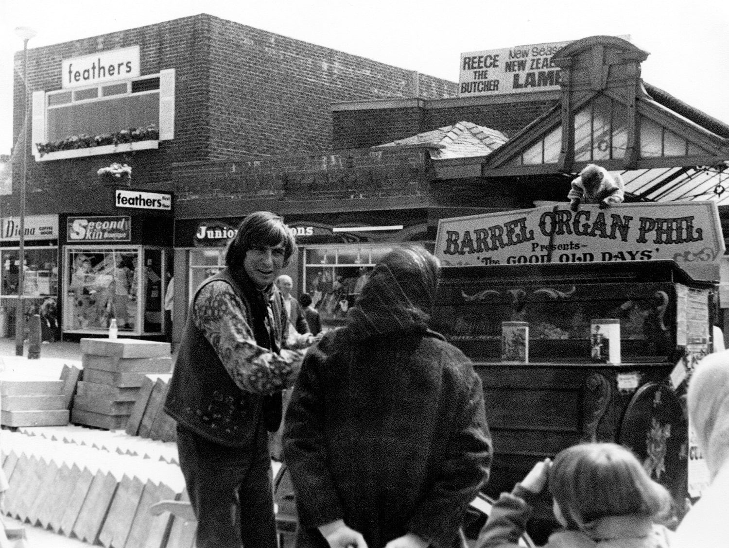 Traditional stall holder with barrel organ and monkey.