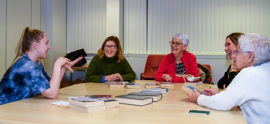 A group of ladies holding a discussion