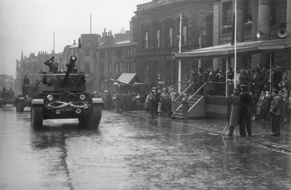 Tank Regiment parade through Oldham Town Centre in 1954 showing tanks driving pass the Town Hall.