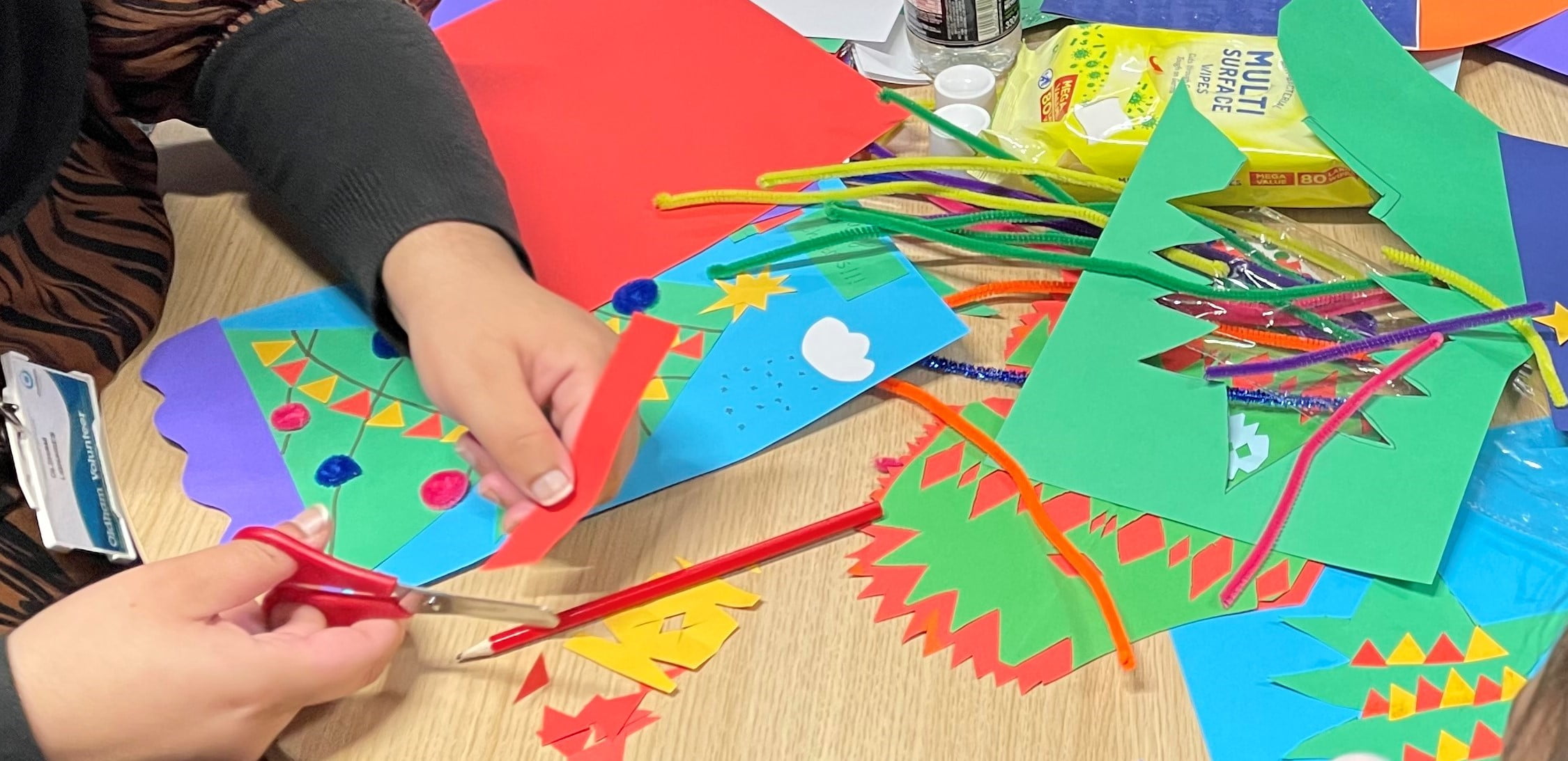 A Person's hands cutting red card