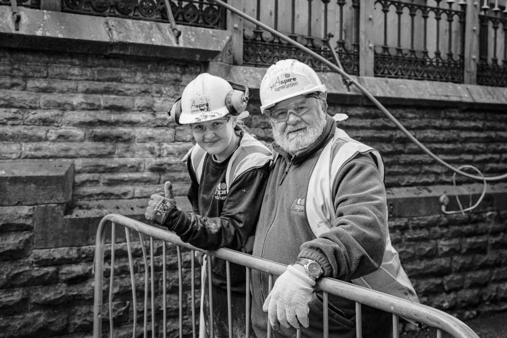 Black and white photograph of two building workers