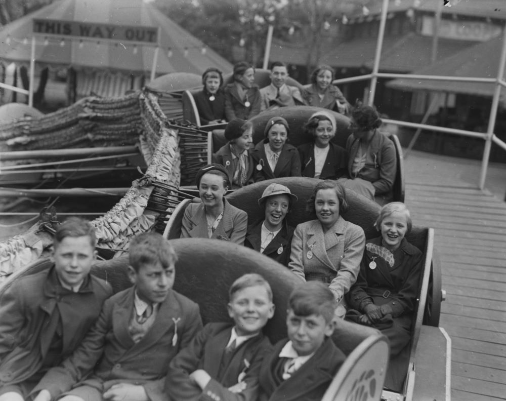 Black and white photograph showing Oldhamers on a funfair ride in the 1930s.