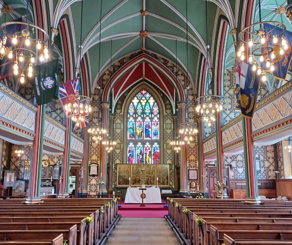 Photograph of the inside of Oldham Parish Church, with the altar in the background centre