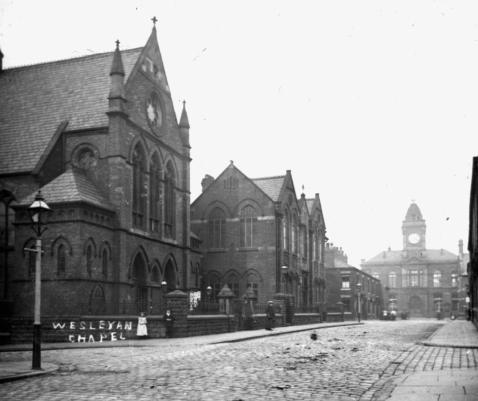 Black and white photograph of the old Wesleyan Chapel in Royton, with the Town Hall in the distance.